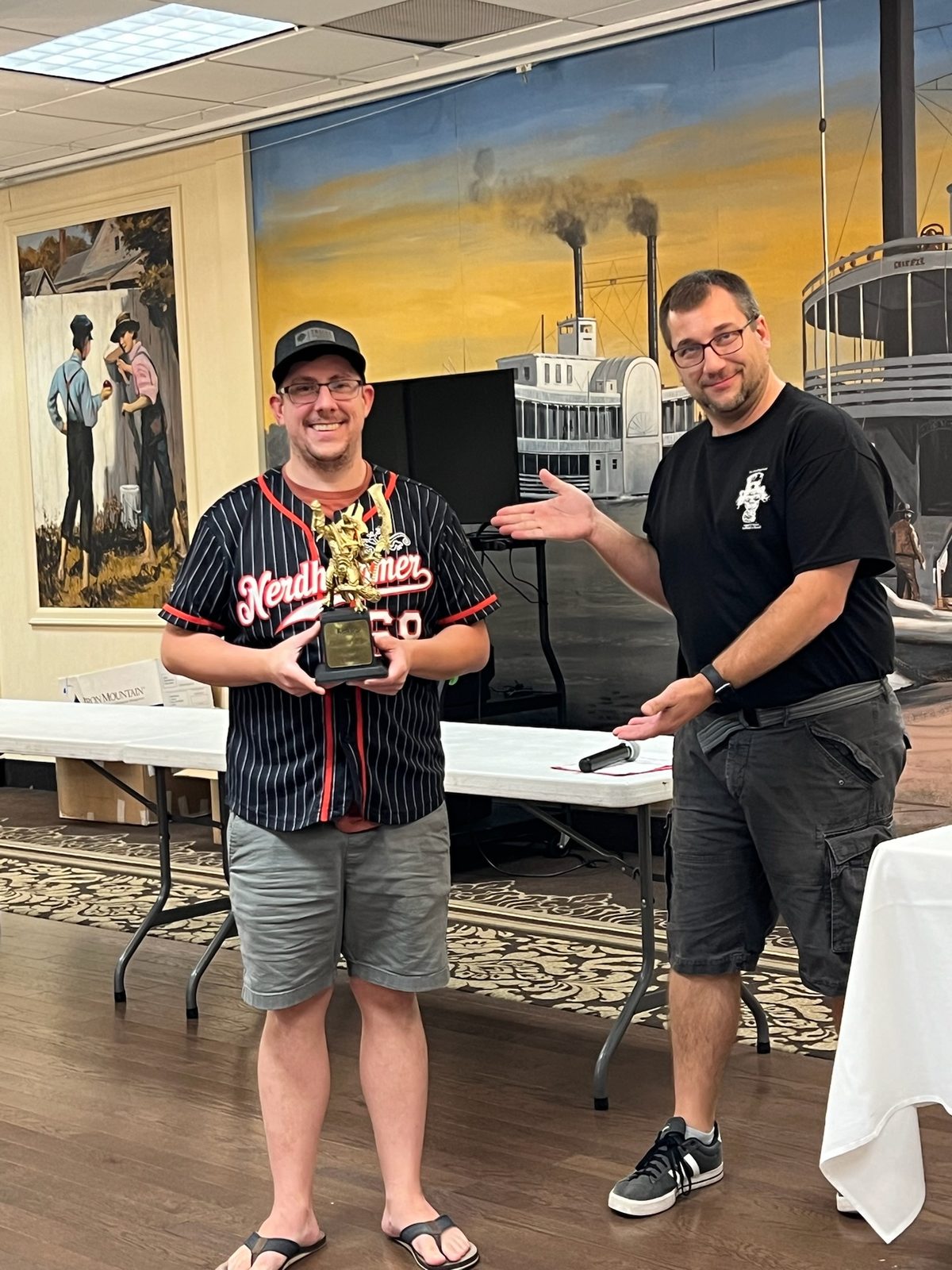 Trophy being handed to a smiling attendee