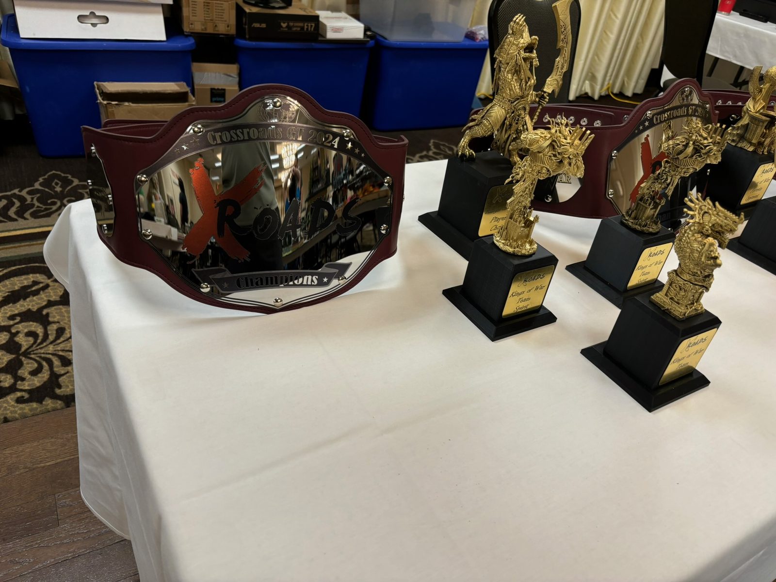 Championship belt and trophies displayed on a table