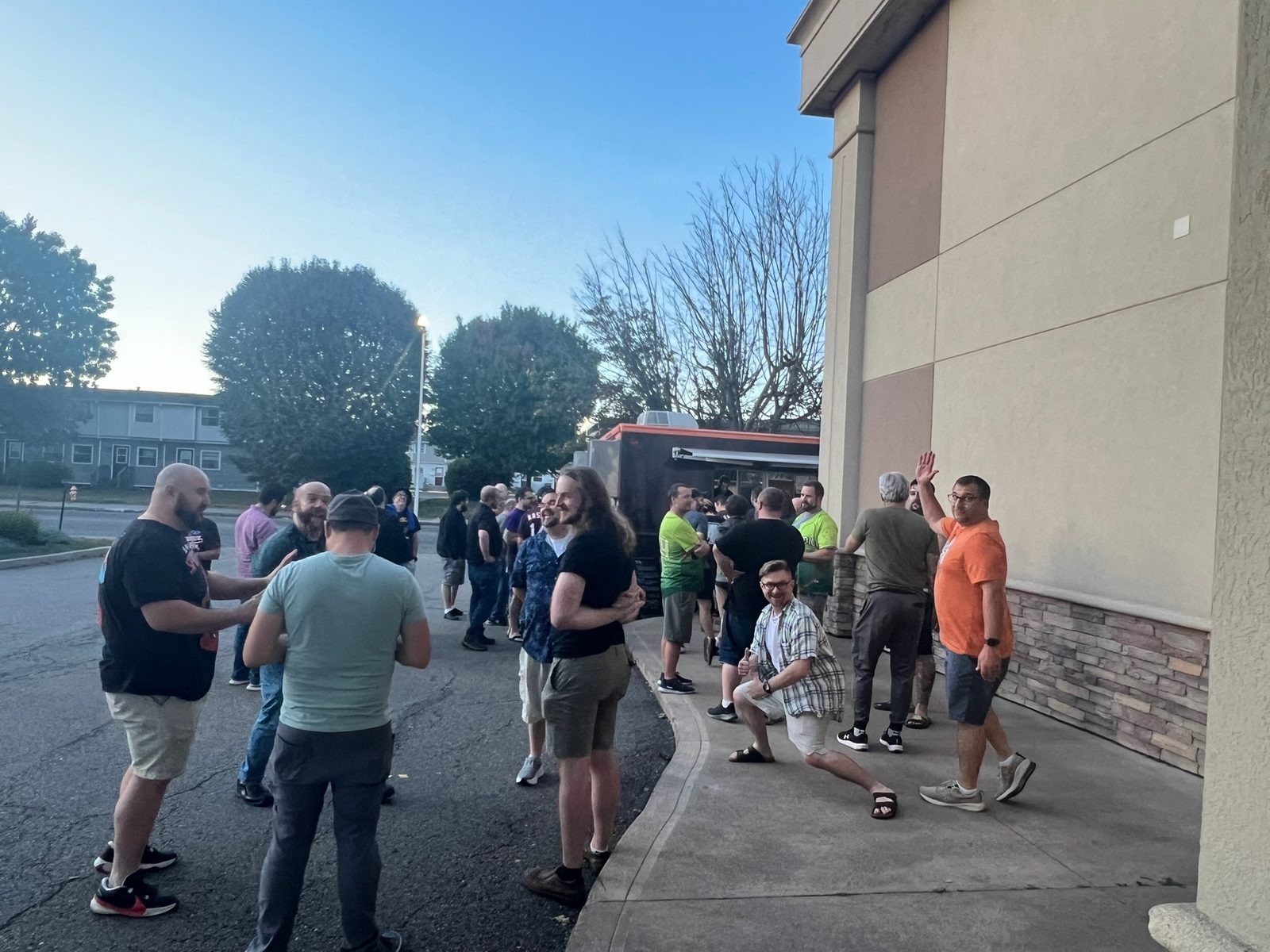 Attendees socializing outside in the evening