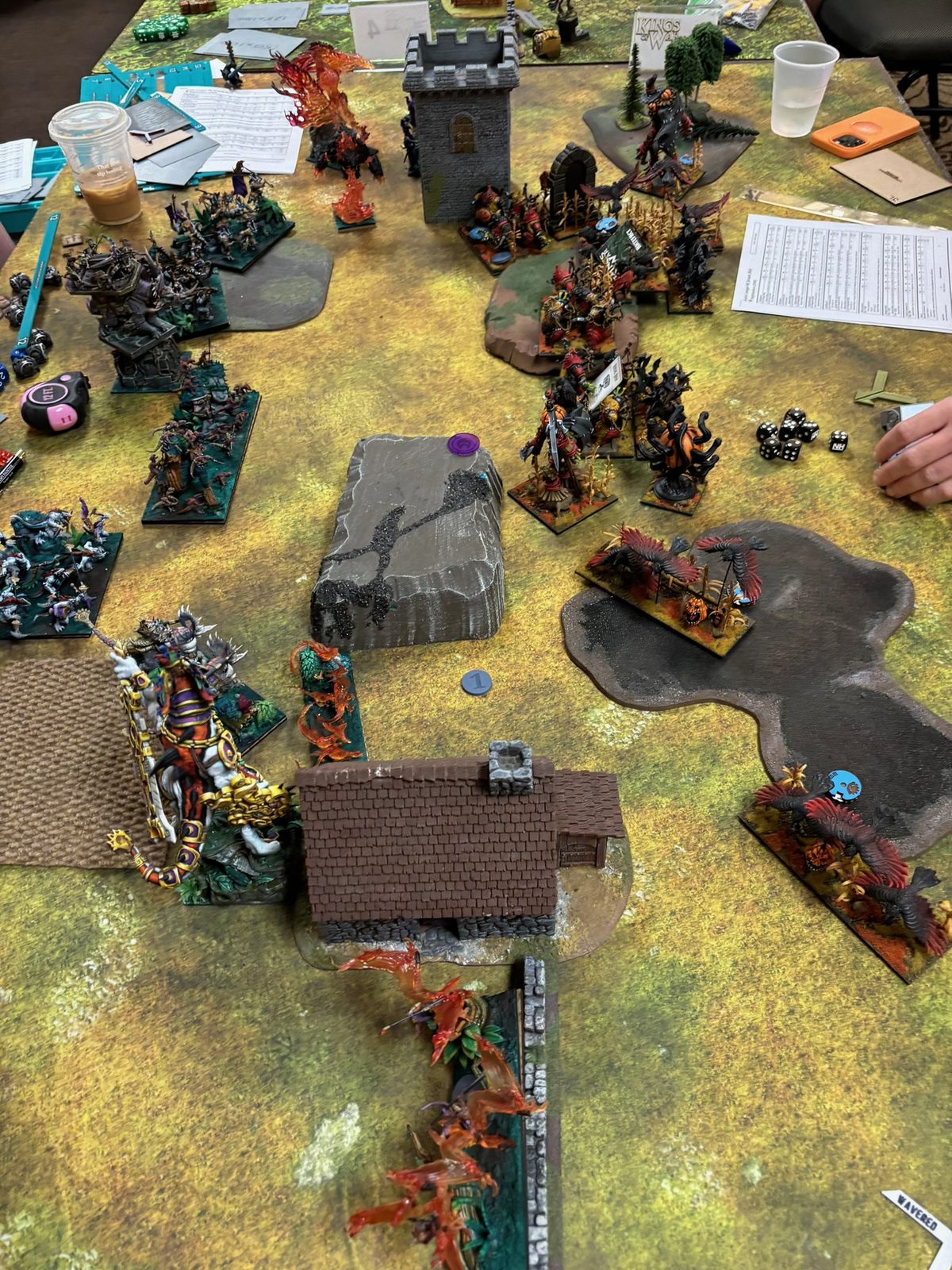Painted armies clash on a terrain-covered Kings of War table